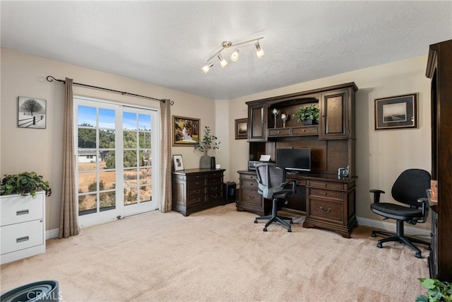 office space with light carpet and a textured ceiling