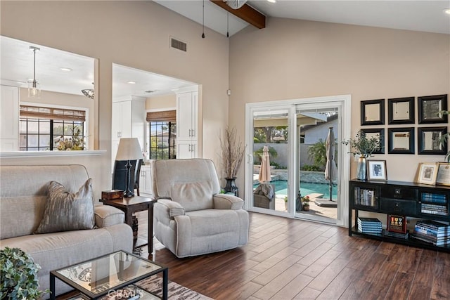 living room featuring dark wood-type flooring, ceiling fan, beam ceiling, and high vaulted ceiling