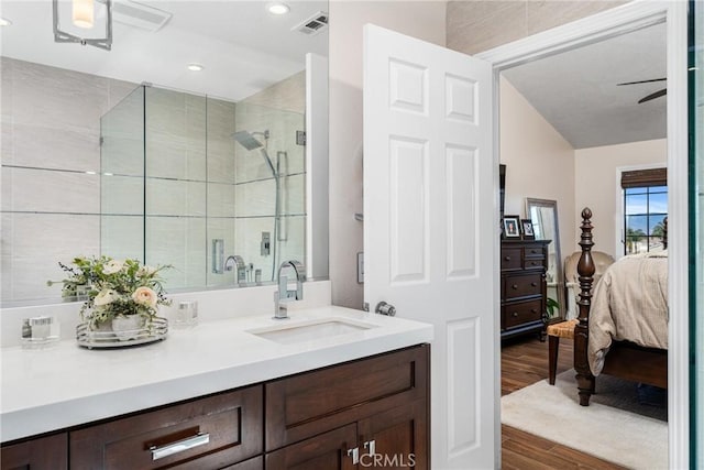 bathroom featuring vanity, wood-type flooring, and a shower with shower door