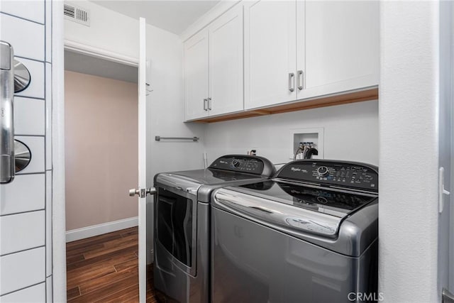 13056 Burns Ln, Redlands, CA 92373 - laundry area with dark wood-style flooring, washer and dryer, cabinet space, and baseboards