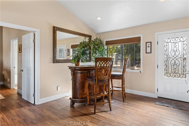 interior space with vaulted ceiling and wood-type flooring