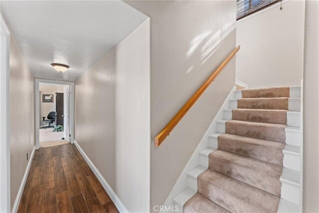 13056 Burns Ln, Redlands, CA 92373 - corridor with wood finished floors, baseboards, and stairway
