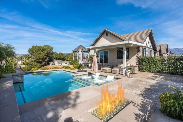 view of pool with a patio area and a fire pit