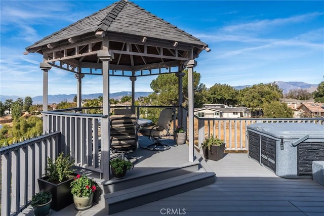 deck featuring a mountain view and a gazebo