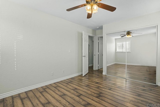 unfurnished bedroom featuring dark wood-type flooring, ceiling fan, and a closet