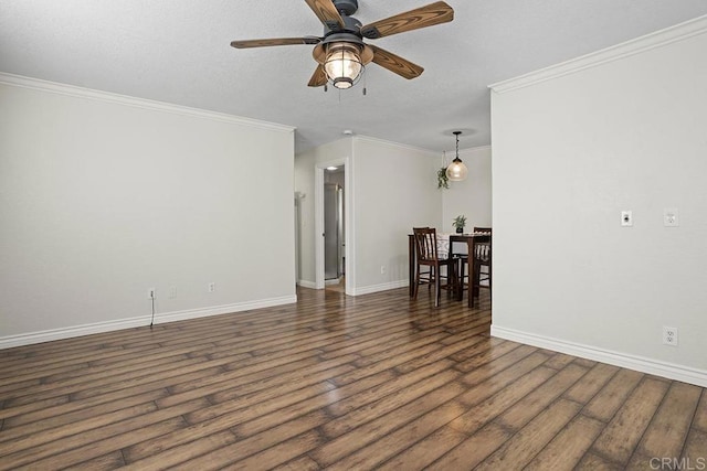 unfurnished room with crown molding, dark wood-type flooring, and ceiling fan