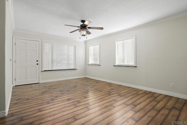 spare room featuring wood-type flooring, ornamental molding, a textured ceiling, and ceiling fan