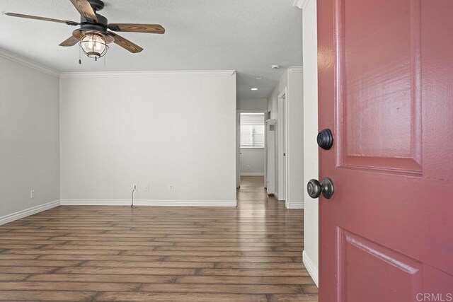 foyer entrance with crown molding, ceiling fan, and dark hardwood / wood-style floors