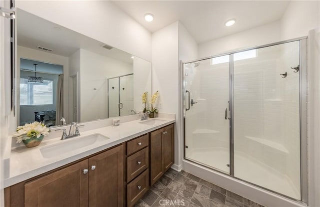 bathroom featuring vanity, a healthy amount of sunlight, and walk in shower