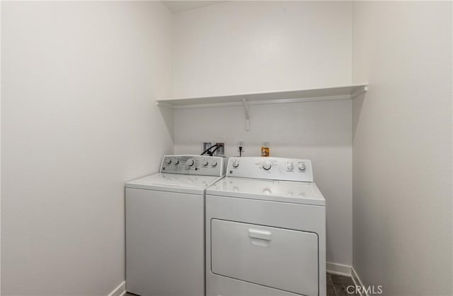 clothes washing area with separate washer and dryer