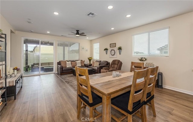 dining area with ceiling fan and light wood-type flooring