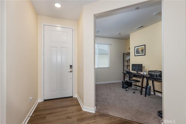 home office with dark hardwood / wood-style flooring