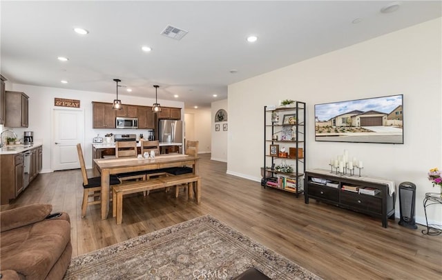 dining room featuring sink and dark wood-type flooring