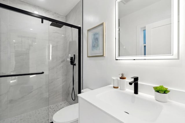 bathroom with vanity, toilet, and walk in shower