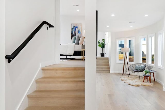 staircase with hardwood / wood-style floors