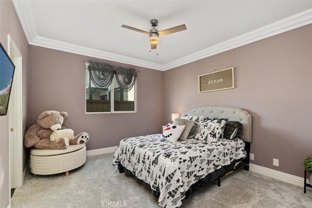 carpeted bedroom featuring ornamental molding and ceiling fan