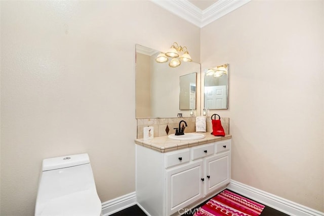 bathroom featuring crown molding, vanity, backsplash, and toilet