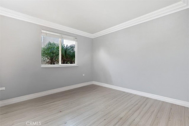 spare room with light hardwood / wood-style flooring and ornamental molding