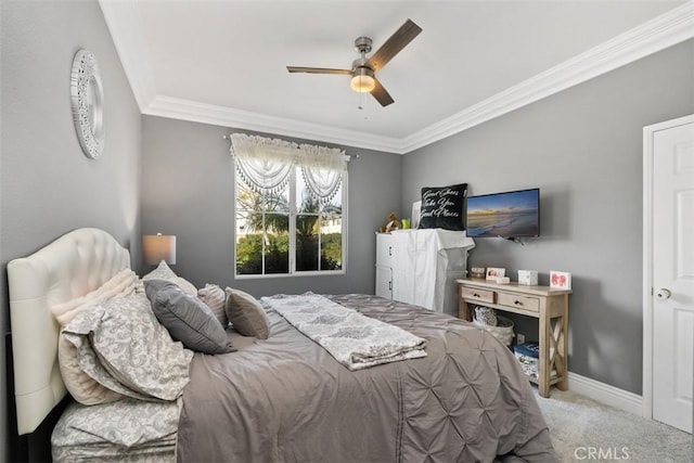 carpeted bedroom with ornamental molding and ceiling fan