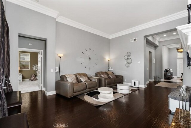 living room with hardwood / wood-style flooring and crown molding