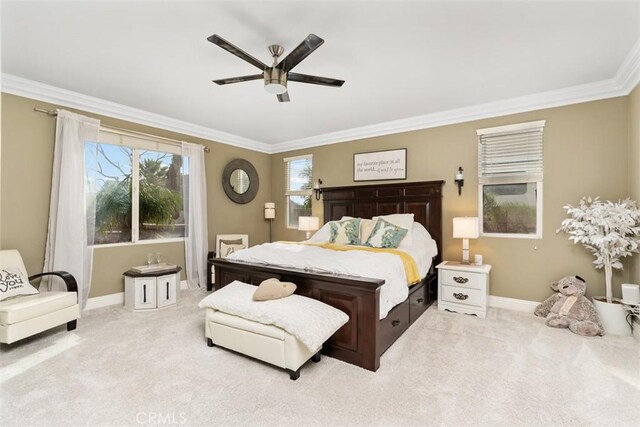 carpeted bedroom with crown molding and ceiling fan