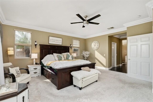 bedroom featuring ceiling fan, light colored carpet, and ornamental molding