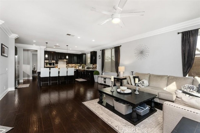 living room featuring dark hardwood / wood-style flooring and ornamental molding