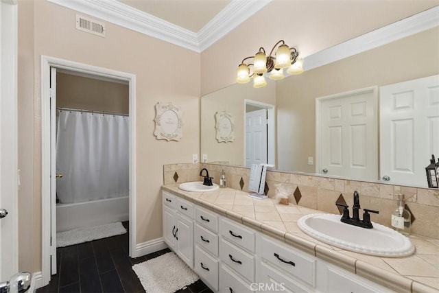 bathroom with vanity, decorative backsplash, ornamental molding, and shower / bath combo