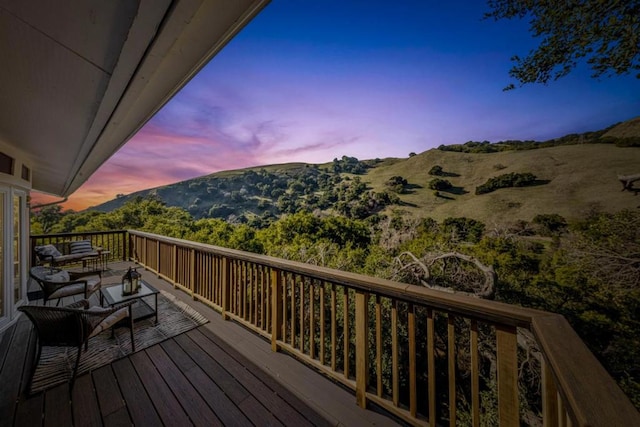 deck at dusk with a mountain view