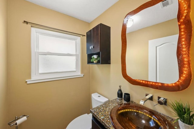 bathroom with vanity and toilet