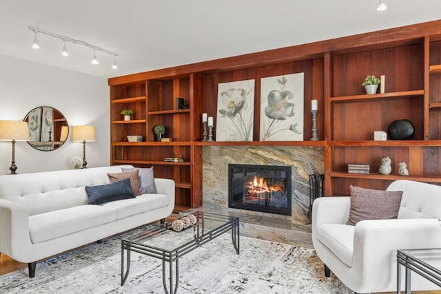 living room featuring built in shelves and a fireplace