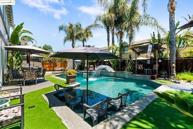 view of swimming pool with a patio, pool water feature, and a shed