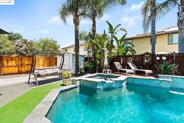 view of swimming pool with a patio and an in ground hot tub