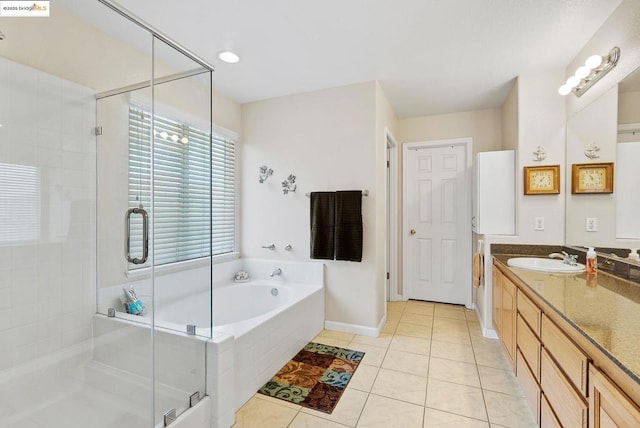 bathroom with plus walk in shower, tile patterned floors, and vanity