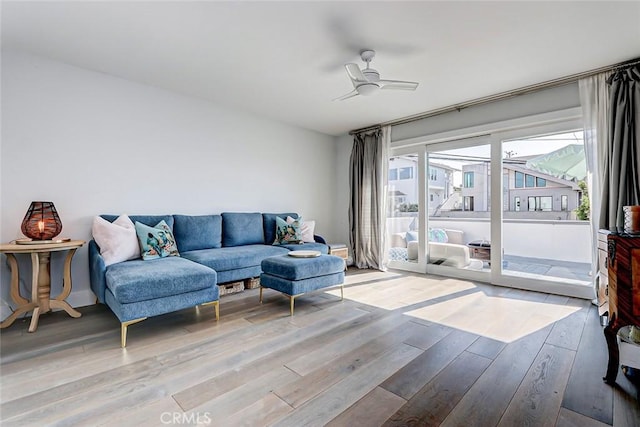 living room with wood-type flooring and ceiling fan