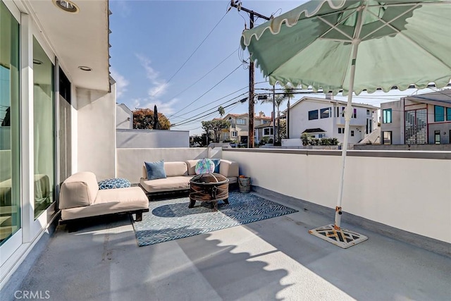 view of patio with an outdoor living space with a fire pit