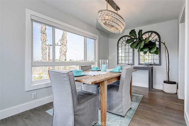 dining room featuring an inviting chandelier, plenty of natural light, and dark hardwood / wood-style floors