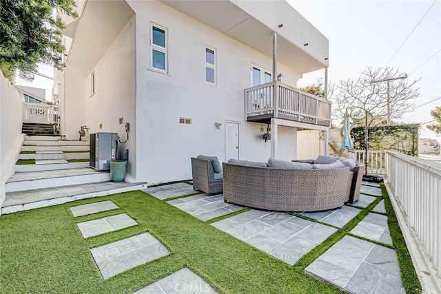 back of house featuring a patio, outdoor lounge area, and cooling unit