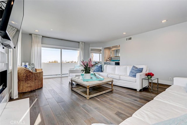 living room featuring wood-type flooring and baseboard heating