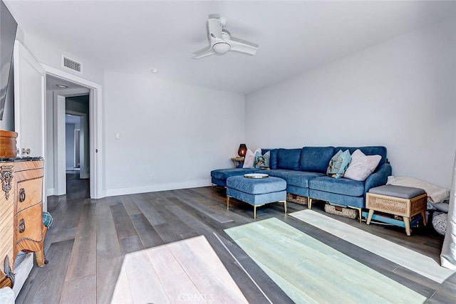 living room with dark wood-type flooring and ceiling fan