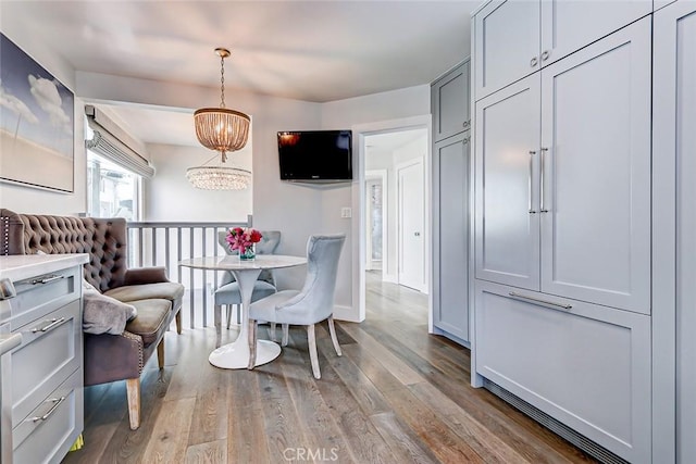 dining area with an inviting chandelier and hardwood / wood-style floors