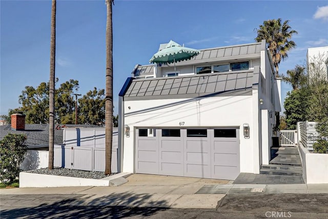 view of front of house featuring a balcony and a garage