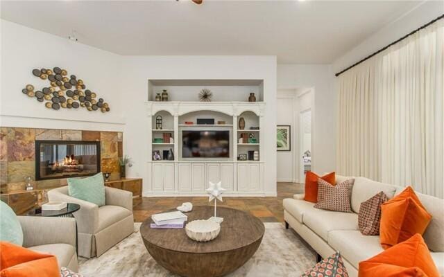 living room featuring built in features and a multi sided fireplace