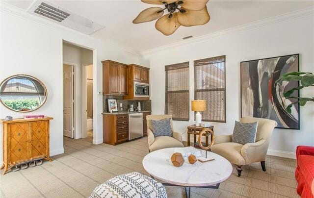 sitting room with crown molding and ceiling fan