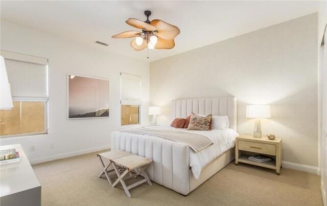 bedroom with ceiling fan and light colored carpet