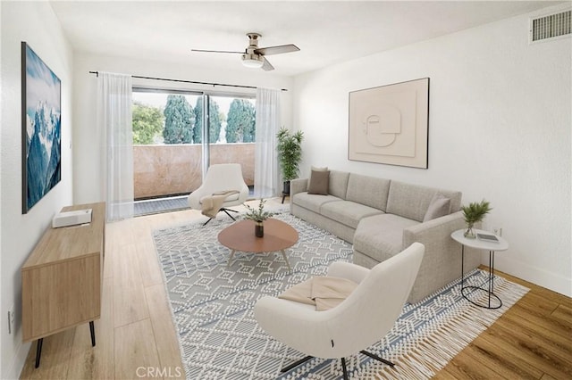 living room with hardwood / wood-style flooring and ceiling fan