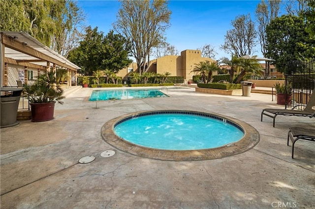 view of swimming pool with an in ground hot tub, a pergola, and a patio