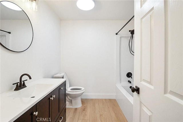 full bathroom with wood-type flooring, bathtub / shower combination, vanity, and toilet