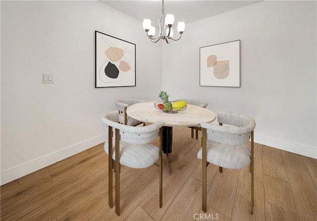 dining room featuring breakfast area, a chandelier, and hardwood / wood-style flooring