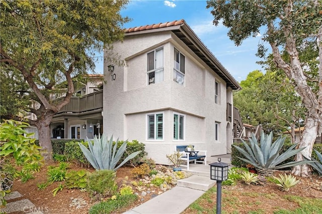 rear view of property featuring a balcony